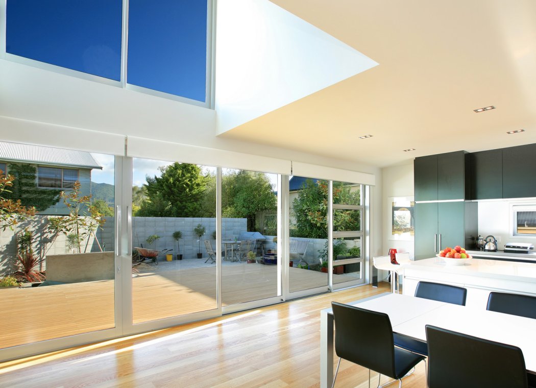 Aluminium sliding doors in a bright modern kitchen and living area